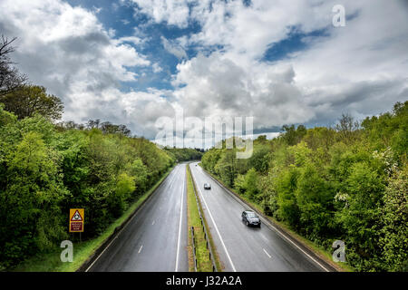 The A264 road between Horsham and Crawley as it cuts through Buchan Park in Crawley, West Sussex Stock Photo