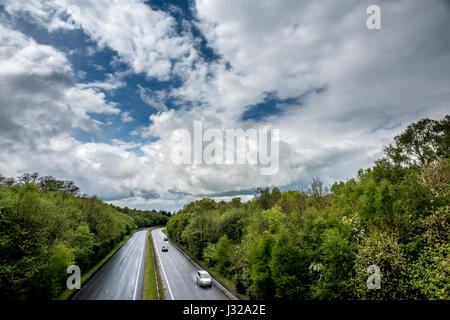 The A264 road between Horsham and Crawley as it cuts through Buchan Park in Crawley, West Sussex Stock Photo