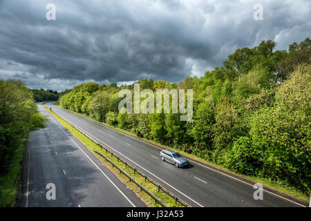 The A264 road between Horsham and Crawley as it cuts through Buchan Park in Crawley, West Sussex Stock Photo