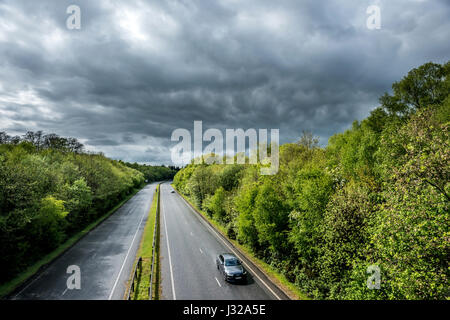 The A264 road between Horsham and Crawley as it cuts through Buchan Park in Crawley, West Sussex Stock Photo