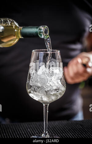 Barman at work, he is preparing cocktails, concept about service and beverages Stock Photo