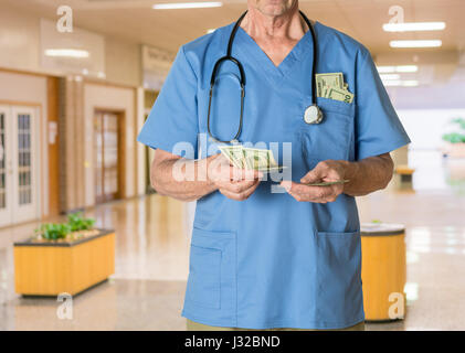 Doctor in scrubs in hospital counting money  - healthcare, health insurance, medical bills concept Stock Photo