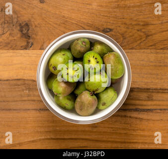Kiwi fruit on a wooden table surface Stock Photo