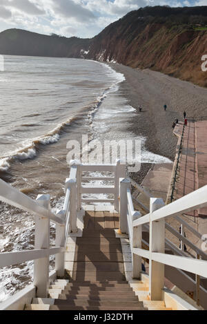 Looking out across the wooden steps of Jacobs ladder and along the beach to the west of Sidmouth, Devon, UK. Part of the Jurassic Coastline. Stock Photo