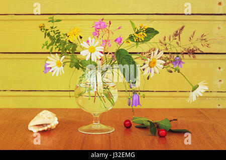 Bouquet of wild flowers in glass Stock Photo