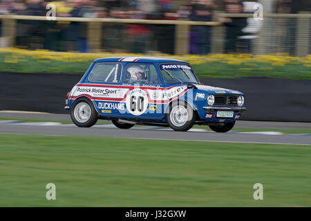 Nick Swift at speed in the giant killing Mini 1275GT at the 75th Goodwood Members Meeting