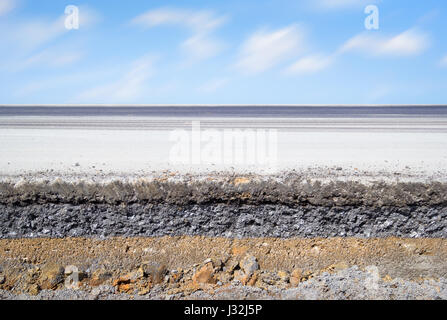 Cross section of asphalt road with blue sky background. Stock Photo