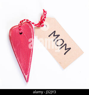 red wooden heart shaped decoration gift with a tag saying mom for mothers day Stock Photo