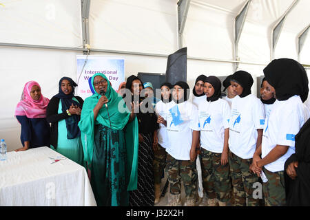 Somali women and female Somali National Army (SNA) soldiers serving under the African Union Mission in Somalia (AMISOM) sing during a ceremony to celebrate the role of female peacekeepers in Mogadishu, Somalia on March 7, 2017. The celebrations preceded the International Women's Day due on March 8, 2017. AMISOM Photo / Omar Abdisalan Stock Photo