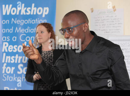Walter Samah address participants, flanked by Judith van den Boogert, Lead trainer and Clingendael Representaive, who address participants during the Amisom training on Negotiation and Mediation as a Conflict Resolution instrument at the KCB Leadership Centre in Karen on 8 March 2017. Photo/Fredrick Omondi Stock Photo