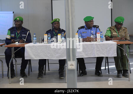 AMISOM Police Training Coordinator, Assistant Commissioner of Police (ACP) Francis Ayitey Aryee (second left) AMISOM Police Chief of Staff Rex Dundun (second right) and AMISOM Police Public Information Officer ASP Janet Shako preside over the closing of induction training for newly deployed police officers serving under the African Union Mission in Somalia (AMISOM), held in Mogadishu, Somalia on 24/03/2017. AMISOM Photo/Allan Atulinda Stock Photo