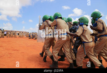 New recruits for the Somali Police Force (SPF) demonstrate crowd control skills during a passing out ceremony to mark the completion of their training in Kismaayo on April 24, 2017. AMISOM Photo Stock Photo