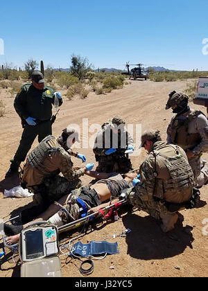 TUCSON, Ariz. – Border Patrol agents from the Casa Grande Station rescued an injured 24-year-old male Honduran national found Tuesday morning near the border southwest of Sells, Arizona. An agent patrolling along the international border found the man lying next to the border road. The man said he was shot three days earlier while still in Mexico. The 24-year-old had applied two tourniquets while stranded in the desert and, at some point, drug himself under the border fence. The agent radioed for assistance from the Border Patrol’s Search, Trauma and Rescue (BORSTAR) team. After the team arriv Stock Photo