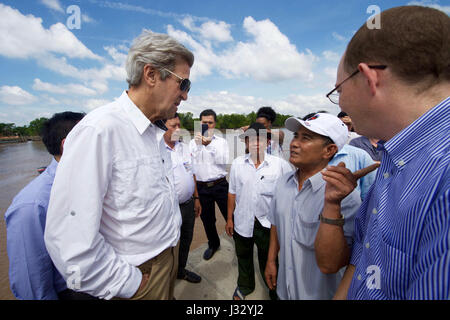 U.S. Secretary of State John Kerry speaks with 70-year-old Vo Ban Tam - who was part of a team that attacked the Secretary's Swift Boat on February 28, 1969, prompting the Secretary to kill his 24-year-old friend and fellow soldier, Ba Thanh. The Secretary and Vo Ban Tam met on January 14, 2017, at the Nam Can Boat and Bus Station in Nam Can, Vietnam, while the Secretary visited the place where he started his career in public service as a U.S. Navy officer, and learned about war reconciliation efforts and work to curb environmental damage in the broader Mekong River Delta. Stock Photo