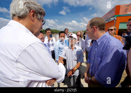 U.S. Secretary of State John Kerry shakes hands with 70-year-old Vo Ban Tam - who was part of a team that attacked the Secretary's Swift Boat on February 28, 1969, prompting the Secretary to kill his 24-year-old friend and fellow soldier, Ba Thanh. The Secretary and Vo Ban Tam met on January 14, 2017, at the Nam Can Boat and Bus Station in Nam Can, Vietnam, while the Secretary visited the place where he started his career in public service as a U.S. Navy officer, and learned about war reconciliation efforts and work to curb environmental damage in the broader Mekong River Delta. Stock Photo