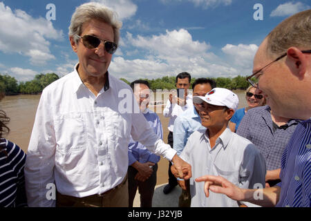 U.S. Secretary of State John Kerry squeezes the hand of 70-year-old Vo Ban Tam - who was part of a team that attacked the Secretary's Swift Boat on February 28, 1969, prompting the Secretary to kill his 24-year-old friend and fellow soldier, Ba Thanh. The Secretary and Vo Ban Tam met on January 14, 2017, at the Nam Can Boat and Bus Station in Nam Can, Vietnam, while the Secretary visited the place where he started his career in public service as a U.S. Navy officer, and learned about war reconciliation efforts and work to curb environmental damage in the broader Mekong River Delta. Stock Photo