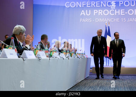 French Foreign Minister Jean-Marc Ayrault escorts French President Francois Hollande after he addressed his guests on January 15, 2017, at the Ministry of Foreign Affairs Conference Center in Paris, France, at the outset of a French-hosted conference on Middle East peace attended by U.S. Secretary of State John Kerry. Stock Photo