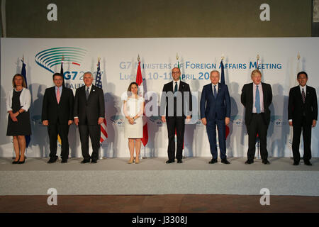 U.S. Secretary of State Rex Tillerson poses for a family photo with his fellow G7+1 counterparts -- from left, European Union High Representative for Foreign Affairs Federica Mogherini, German Foreign Minister Sigmar Gabriel, Canadian Foreign Minister Chrystia Freeland, Italian Foreign Minister Angelino Alfano, France Foreign Minister Jean-Marc Ayrault, British Foreign Secretary Boris Johnson, and Japanese Foreign Minister Fumio Kishida -- in Lucca, Italy, on April 11, 2017. Stock Photo