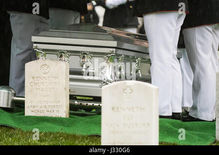 Former astronaut and U.S. Senator John Glenn's casket is seen as he is laid to rest at Arlington National Cemetery in Virginia on Thursday, April 6, 2017, the day on which he and his wife Annie were married in 1943. Glenn was the first American to orbit Earth on Feb. 20, 1962, in a five-hour flight aboard the Friendship 7 spacecraft. In 1998, he broke another record by returning to space at the age of 77 on the Space Shuttle Discovery.  Photo Credit: (NASA/Aubrey Gemignani) Stock Photo