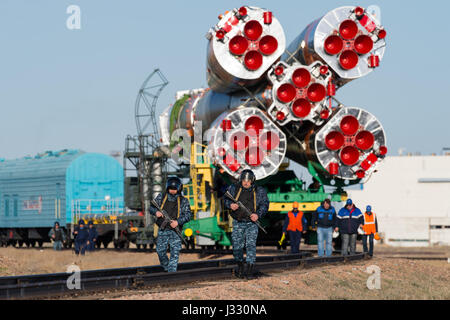 Russian security is seen as the Soyuz MS-04 spacecraft is rolled out to the launch pad by train on Monday, April 17, 2017 at the Baikonur Cosmodrome in Kazakhstan.  Launch of the Soyuz rocket is scheduled for April 20 and will carry Expedition 51 Soyuz Commander Fyodor Yurchikhin of Roscosmos and Flight Engineer Jack Fischer of NASA into orbit to begin their four and a half month mission on the International Space Station.Photo Credit: (NASA/Aubrey Gemignani) Stock Photo