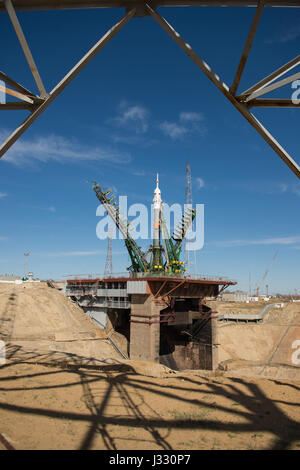 The gantry arms close around the Soyuz MS-04 spacecraft to secure the rocket at the launch pad on Monday, April 17, 2017 at the Baikonur Cosmodrome in Kazakhstan.  Launch of the Soyuz rocket is scheduled for April 20 Baikonur time and will carry Expedition 51 Soyuz Commander Fyodor Yurchikhin of Roscosmos and Flight Engineer Jack Fischer of NASA into orbit to begin their four and a half month mission on the International Space Station. Photo Credit: (NASA/Aubrey Gemignani) Stock Photo