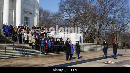 NASA personnel watch as a wreath is laid at the Tomb of the Unknowns by acting NASA Administrator Robert Lightfoot and June Scobee-Rodgers,  as part of NASA's Day of Remembrance, Tuesday, Jan. 31, 2017, at Arlington National Cemetery in Arlington, Va.  The wreaths were laid in memory of those men and women who lost their lives in the quest for space exploration. Stock Photo