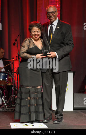 NASA Associate Administrator for Education Donald James, right, presents  Janet Sellars, acting associate administrator for Diversity and Equal Opportunity at NASA Headquarters, with the Corporate Promotion of Education award during the 31st Black Engineer of the Year Awards Gala on Saturday, Feb. 11, 2017 at the Washington Marriott Wardman Park Hotel in Washington, DC.  Sellars was presented the Corporate Promotion of Education award and Allen Parker, a research engineer at NASA's Armstrong Flight Research Center was presented with the Career Achievement in Government award during the event. Stock Photo