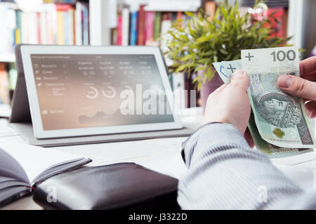 Man holds money. Personal finance manager application in background Stock Photo
