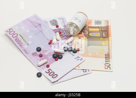 Euro banknotes and medical pills. Concept of expensive health care Stock Photo