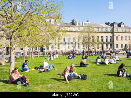 People sitting on the grass on a sunny day in Eldon Square, Newcastle upon Tyne, England, UK Stock Photo