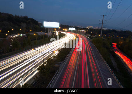 Car Light Traces From Moving On Highway At Dusk Stock Photo