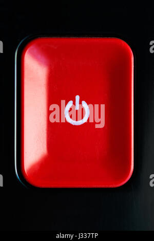 Red plastic rectangle power button with icon on black background Stock ...