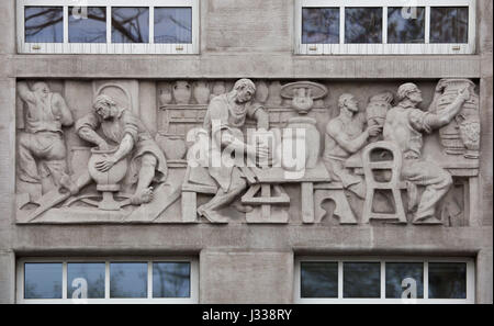 Pottery production. Relief by Hungarian sculptor Laszlo Huvos (1930) on the north wing of the Art Deco building of the Budapest Workers Insurance Fund in Budapest, Hungary. The building, now used as the seat of the National Social Insurance Centre (OTI), was designed by Hungarian architects Marcell Komor and Dezso Jakab and built in 1913. The north wing was added by architect Aladar Sos in 1930-1931. Stock Photo