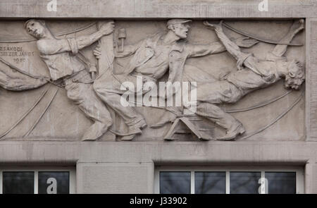 Electric shock. Relief by Hungarian sculptor Janos Zsakodi Csiszer (1930) on the north wing of the Art Deco building of the Budapest Workers Insurance Fund in Budapest, Hungary. The building, now used as the seat of the National Social Insurance Centre (OTI), was designed by Hungarian architects Marcell Komor and Dezso Jakab and built in 1913. The north wing was added by architect Aladar Sos in 1930-1931. Stock Photo