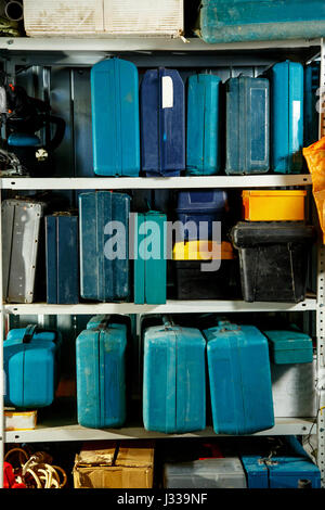 Boxes of tools on shelves in garage Stock Photo