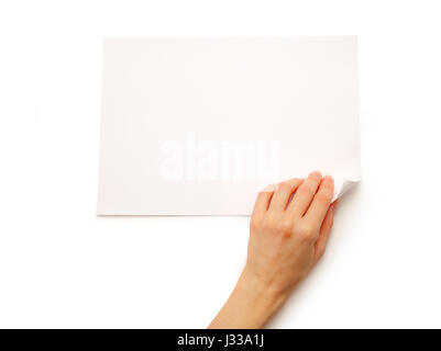 Woman's hand turning over sheet of paper Stock Photo