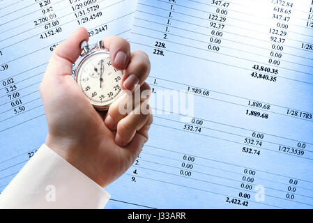 Operating budget and stopwatch in male hand Stock Photo