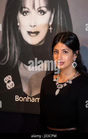 London, UK. 2 May 2017. A Bonhams employee wears a diamond, emerald, stone and platinum necklace, est. USD 40,000-60,000. Bonhams London presents highlights from the forthcoming sale of Jackie Collins estate 'A Life in Chapters' which will take place on 16-17 May 2017 at Bonhams in Los Angeles. Stock Photo
