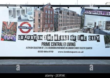 Property advert hoarding advertising luxury living apartments near the Spitalfields Tower Hamlets area of the East End of London UK  KATHY DEWITT Stock Photo