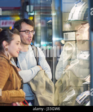 Woman and man in front of clothing store Stock Photo