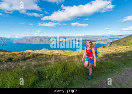 Walker on hiking trail to Roys Peak, Lake Wanaka, Southern Alps, Otago Region, Southland, New Zealand Stock Photo