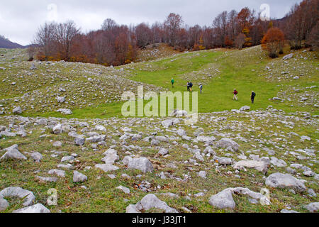 Hikers on the Piano de Pollino plain in Pollino National Park Stock Photo