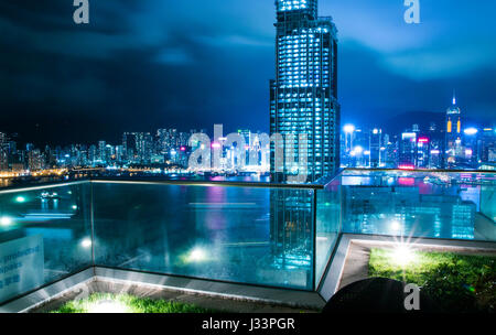 Magnificent skyline view over Hong Kong Chine from a glass balcony at night Stock Photo