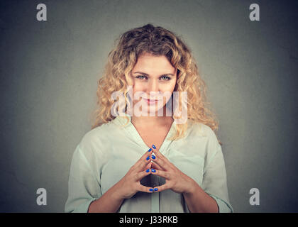 Closeup portrait of sneaky, sly, scheming young woman plotting something isolated on gray background. Negative human emotions, facial expressions, fee Stock Photo