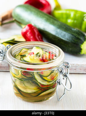 Marinated zucchini salad canned in glass jar Stock Photo