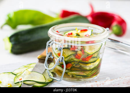 Marinated zucchini salad canned in glass jar Stock Photo