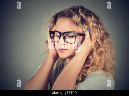 Closeup portrait sad young beautiful woman with worried stressed face expression looking overwhelmed Stock Photo