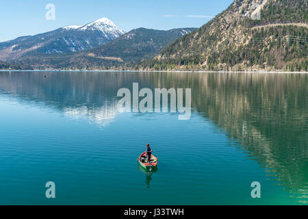 Angler in seinem Ruderboot auf dem Walchensee,  Kochel am See, Bayern, Deutschland  |  Angler fishing from his rowing boat on Lake Walchen, Kochel am  Stock Photo