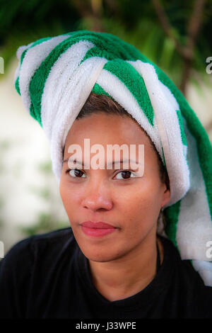 Portrait of a beautiful Filipino woman with a towel wrapped around her hair turban style. Stock Photo