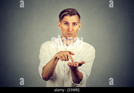 Young handsome man asking for more money to pay back debt Stock Photo